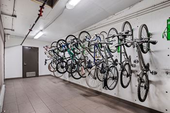 A bike rack with many bikes hanging on it.